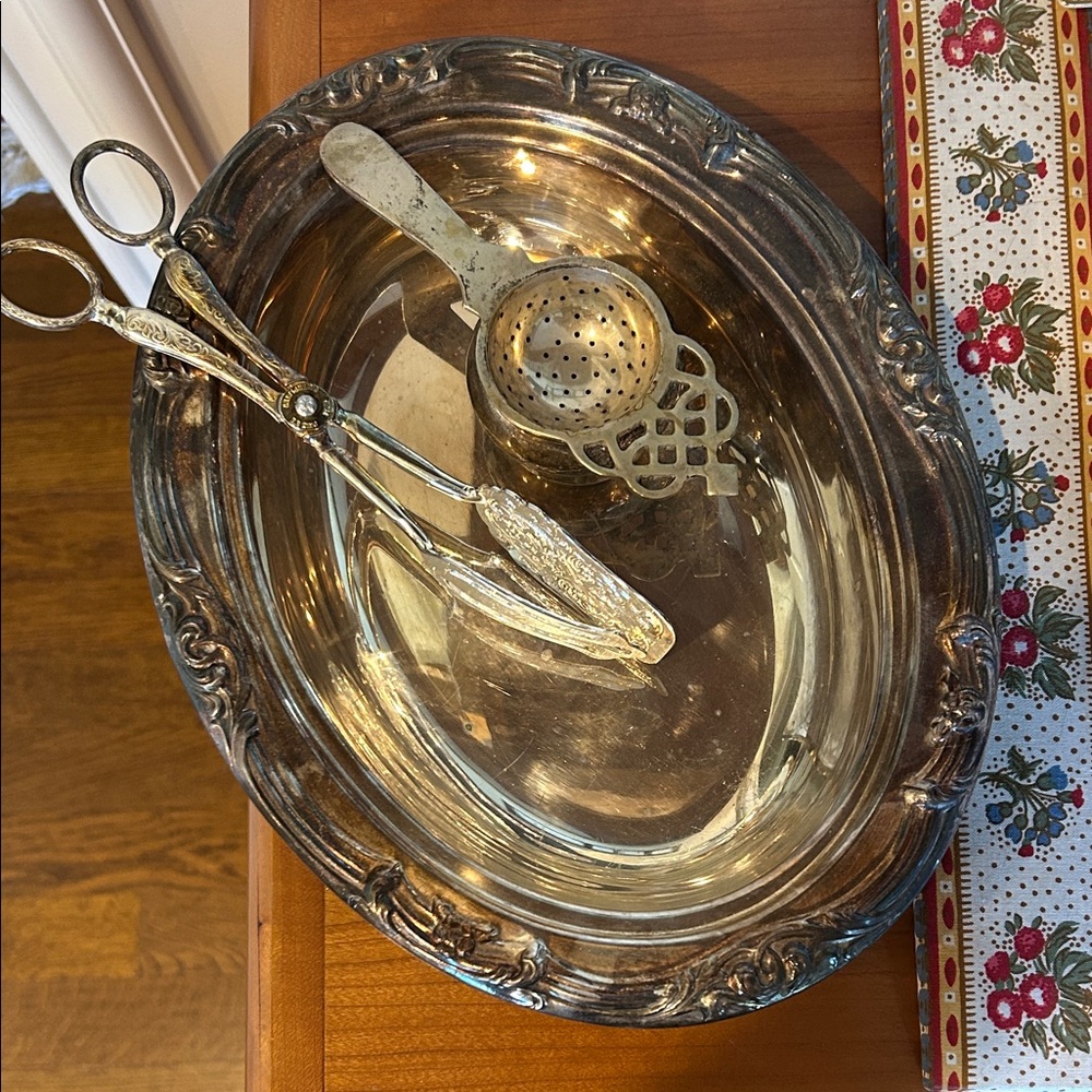 Silver toned (plated?) dish, serving tongs and tea strainer.